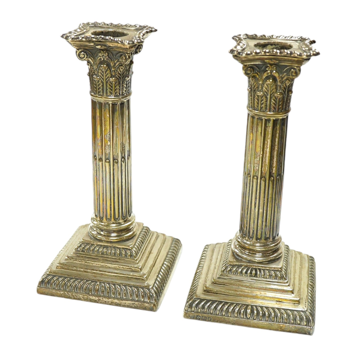 A pair of late Victorian silver Corinthian column dwarf candlesticks, Hawksworth, Eyre & Co, Sheffield, 1899, height 17.4cm, weighted. Condition - poor to fair